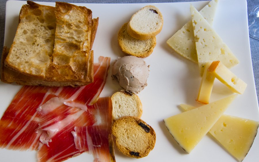 Cheese and Spanish ham served on a plate for sharing